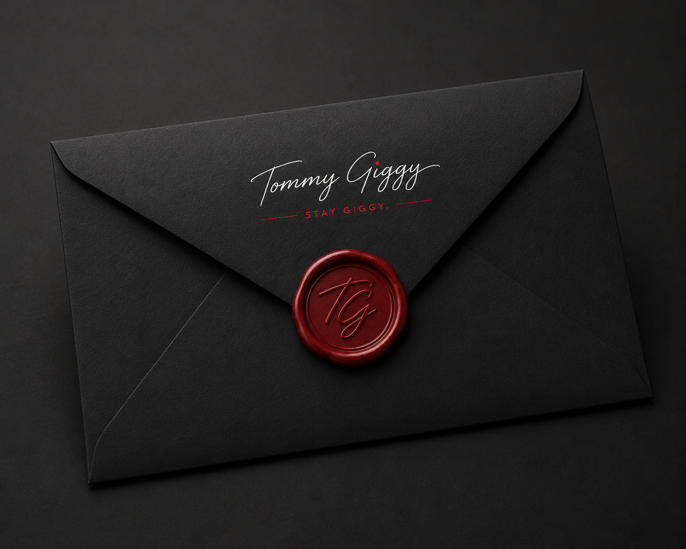 Tommy Giggy black envelope packaging with red wax seal